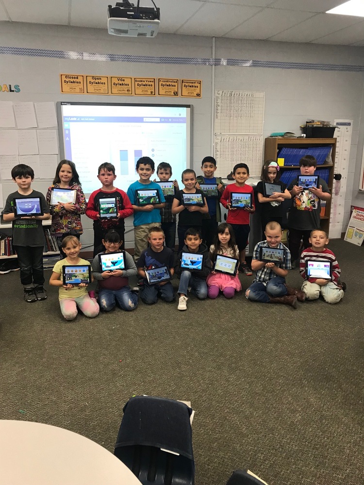 First Grade Class holding their tablets