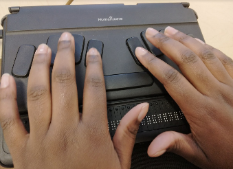 Student using Braille keyboard